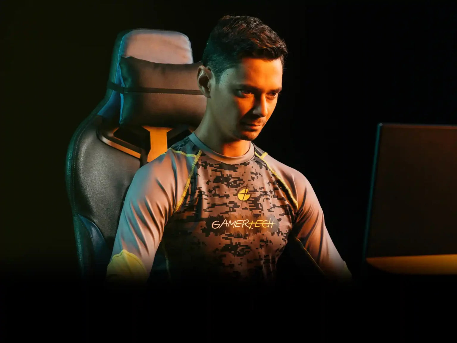 Esports player wearing the GamerTech Pro Jersey looking at a PC